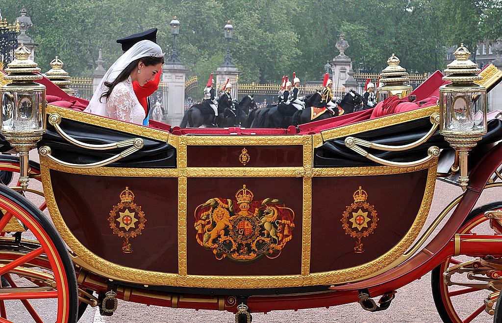LONDON, ENGLAND - APRIL 29: TRH Prince William, Duke of Cambridge and Catherine, Duchess of Cambridge make the journey by carriage procession to Buckingham Palace following their marriage at Westminster Abbey on April 29, 2011 in London, England. The marriage of the second in line to the British throne was led by the Archbishop of Canterbury and was attended by 1900 guests, including foreign Royal family members and heads of state. Thousands of well-wishers from around the world have also flocked to London to witness the spectacle and pageantry of the Royal Wedding. (Photo by John Stillwell-WPA Pool/Getty Images)