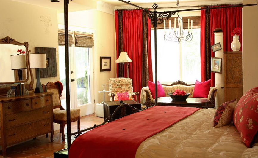 An element which would coordinate well with red curtains is a canopy bed 