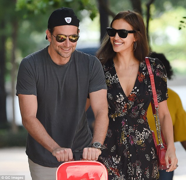 Smiles! Bradley Cooper, 43, and Irina Shayk, 32, were spotted smiling together as they took their one-year-old daughter Lea for a stroll in New York