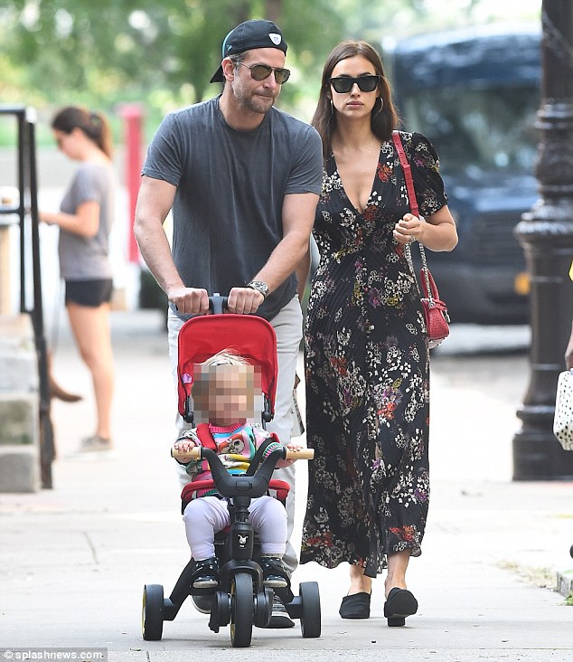 Busy bees: Both parents were spotted this week hard at work with Irina on a shoot and Bradley promoting his new movie A Star Is Born