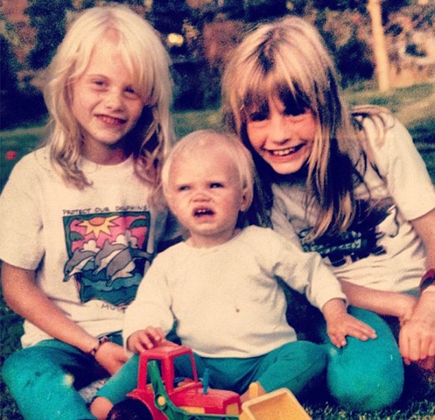 Back in the day: Cara, centre, with her big sisters as children - and they have certainly blossomed
