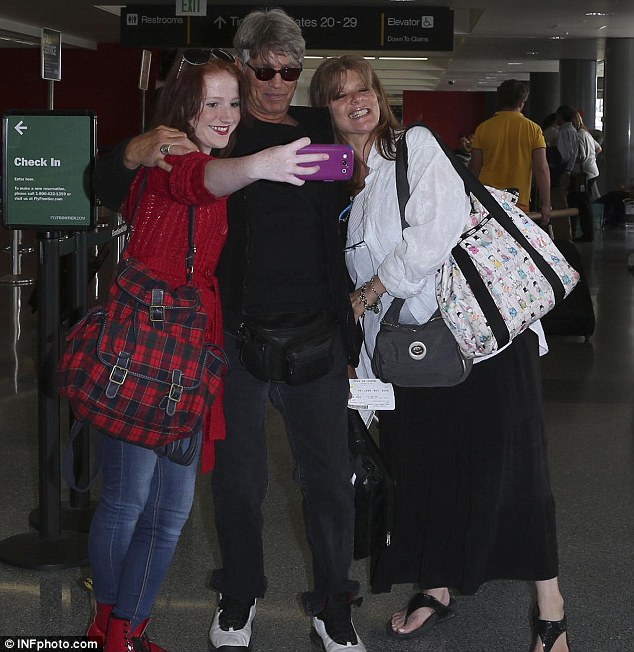 Group shot: Eric and Eliza got close for a photo together at the airport