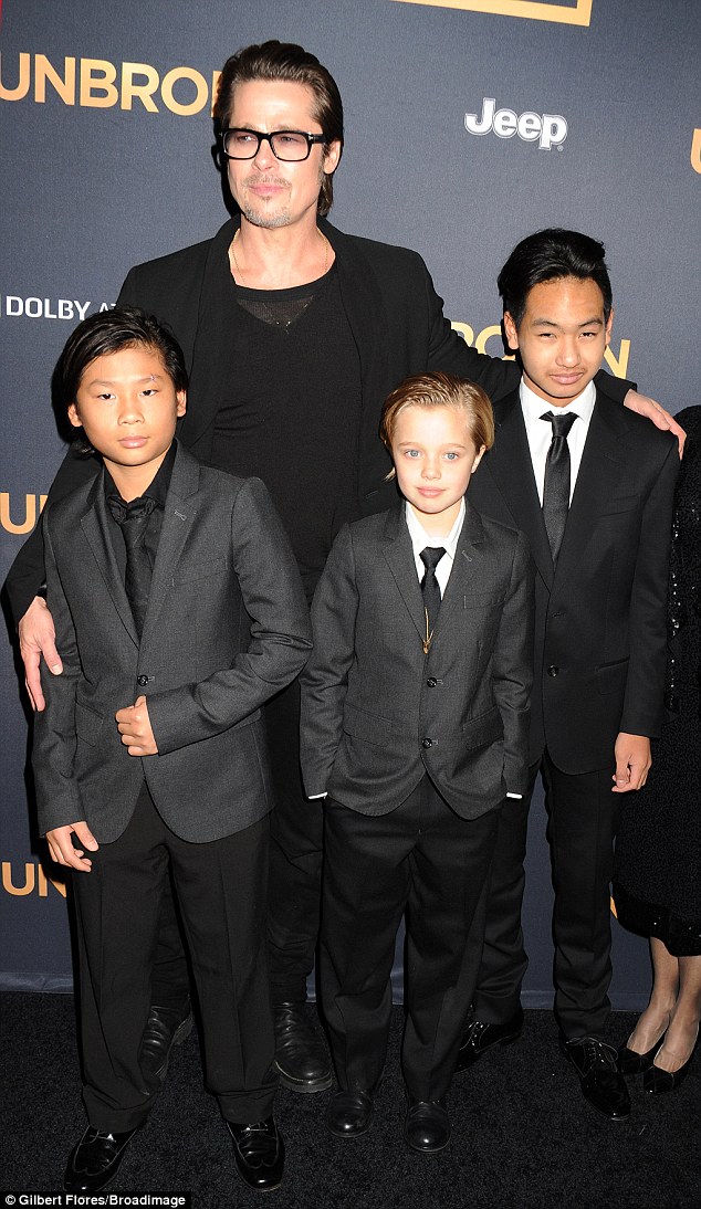 Matching suits! Brad sweetly filled in for his infectious wife of four months at the Hollywood premiere of Unbroken on Monday 