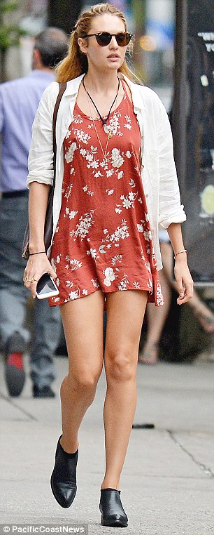 Always in style: The Maxim cover girl looked pretty in her casual attire. A rust-colored floral minidress showed off her toned legs. Black short boots and a white shirt finished off her day-off look