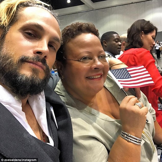 Runs in the family: Saldana and her husband Marco, pictured at his U.S. citizenship ceremony this week with the actress