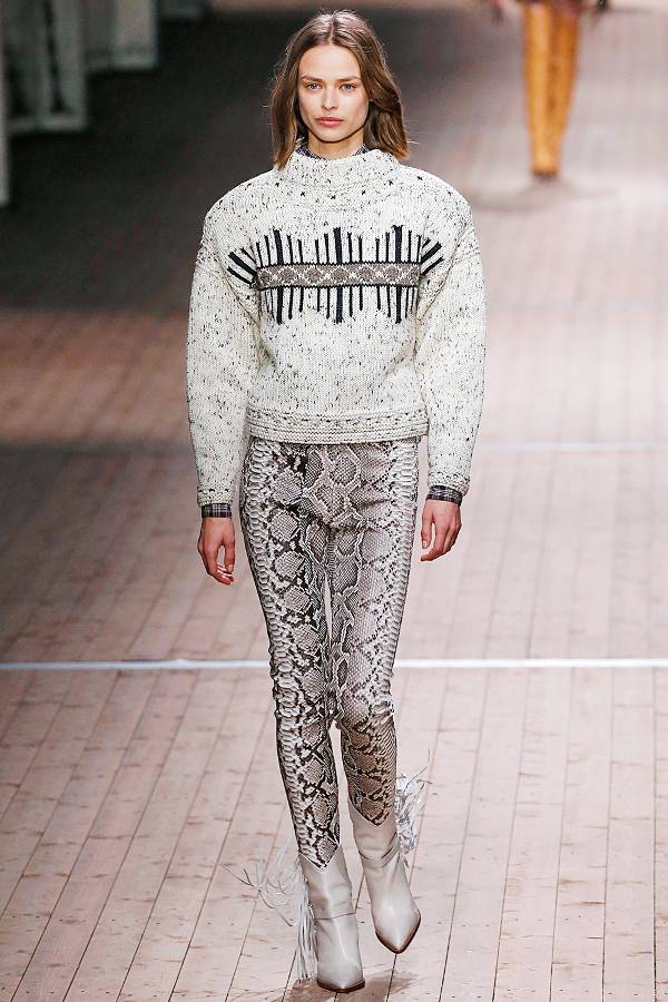 Модель в брюках со змеинным принтом и сером свитере